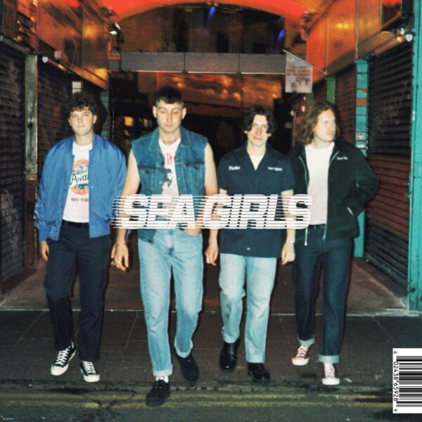 The front cover of Sea Girls' Homesick album. The band are in a line, walking towards the camera through an urban alleyway.