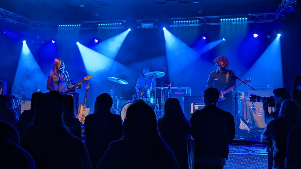 Viji and her band on stage in a wash of blue lights at the Wedgewood Rooms.