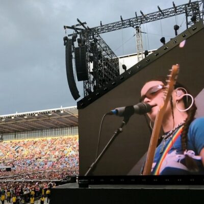 Wet Leg live in Coventry. Rhian is shown on the big screen with thousands of music lovers filling the stadium.