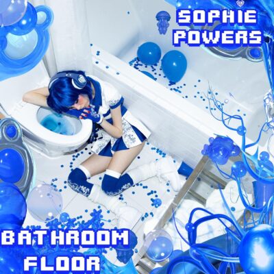 Sophie Powers - Bathroom Floor. A stark blue and white scene of a bathroom, with Sophie sleeping with her head resting on the toilet seat. Balloons and confetti give the impression that a party has taken place.