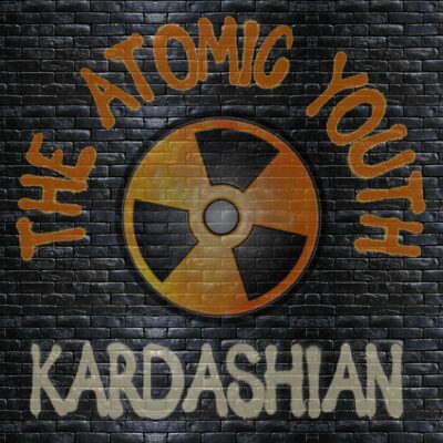 The Atomic Youth - Kardashian. Styled to look like it's spray painted on a dark brick wall.