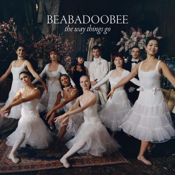 Beabadoobee - The Way Things Go. A photograph of a group of ballerinas in white, with Beabadoobee stood amongst them wearing black.
